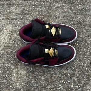 Maroon, gold and black low top Jordan’s